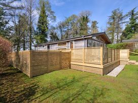 A cabin surrounded by wooden fencing and grass at 3 Faraway Fields in Dobwalls