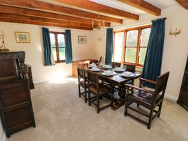 A dining room with a table and chairs at Park Hall Cottage in Solva