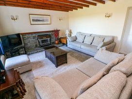 A living room with sofas and a coffee table at Park Hall Cottage Solva