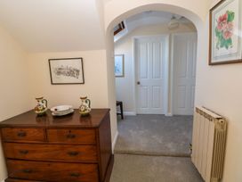 A hallway with a dresser and vases at Park Hall Cottage in Solva