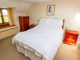 A bedroom with a bed and bedside tables at Park Hall Cottage in Solva
