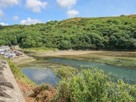 An outdoor view of a river with cars parked nearby at Park Hall Cottage, Solva