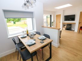 A dining area with a table and chairs at Y Bwthyn in Burry Port