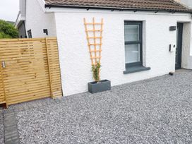 An outdoor area with a fence and planter at Y Bwthyn Burry Port