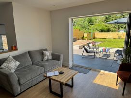A living room with a sofa and coffee table at Y Bwthyn in Pembrey