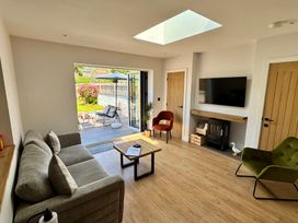 A living room with seating and a coffee table at Y Bwthyn in Pembrey