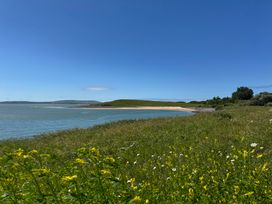 A coastal landscape with grass and beach at Y Bwthyn in Pembrey
