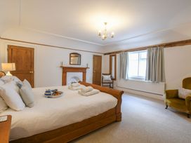 A bedroom with a bed and chair at Beresford House in Woodbridge