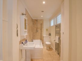 A bathroom with a bathtub, sink, toilet, and shower at Beresford House in Woodbridge