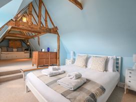 A bedroom with a bed and a sitting area at Beresford House in Woodbridge