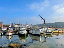 A harbor with moored boats and a crane at Beresford House in Woodbridge