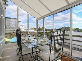 A dining setup with a glass table and chairs at Beresford House in Woodbridge