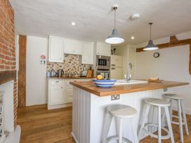 A kitchen with cabinets and island at Beresford House in Woodbridge