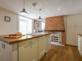 A kitchen with a sink and island at Beresford House in Woodbridge