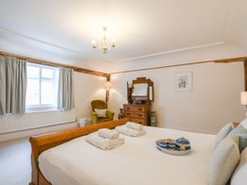 A bedroom with a bed and mirror at Beresford House Woodbridge