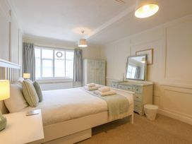A bedroom with a bed and mirror at Beresford House in Woodbridge