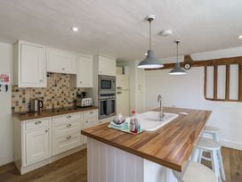 A kitchen with cabinets and appliances at Beresford House in Woodbridge