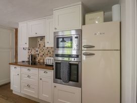 A kitchen with cabinets and appliances at Beresford House Woodbridge