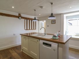 A kitchen with a wooden island and sink at Beresford House in Woodbridge