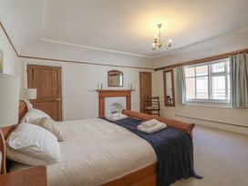A bedroom with a bed and a chair at Beresford House in Woodbridge