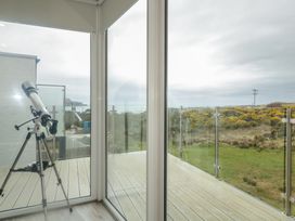 A conservatory with a telescope and views of hills at 2 Ard an Chuain Dunfanaghy