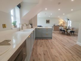 A kitchen with a countertop, sink, and dining area at 2 Ard an Chuain Dunfanaghy