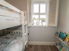 A bedroom with a bunk bed and bookshelf at 2 Ard an Chuain Dunfanaghy