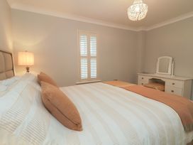 A bedroom with a bed and vanity at 2 Ard an Chuain Dunfanaghy