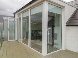 A deck with a glass door and telescope at 2 Ard an Chuain Dunfanaghy
