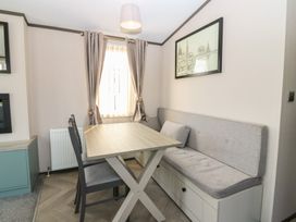 A dining area with a table and bench seating at Plot 243 - Coldingham Bay Leisure Park in Eyemouth