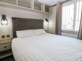 A bedroom with a bed and bedside lights at Plot 243 - Coldingham Bay Leisure Park Eyemouth