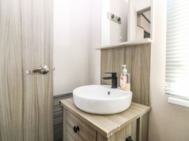 A bathroom with a sink and cabinet at Plot 243 - Coldingham Bay Leisure Park Eyemouth