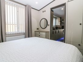 A bedroom with a bed and closet at Plot 243 - Coldingham Bay Leisure Park Eyemouth
