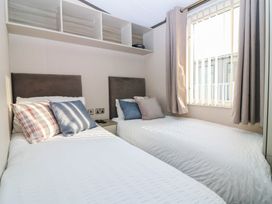 A bedroom with two beds and a window at Plot 243 - Coldingham Bay Leisure Park Eyemouth