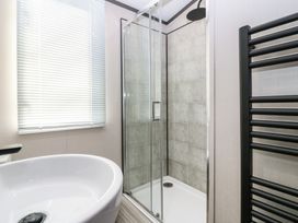 A bathroom with a bathtub and a shower at Plot 243 - Coldingham Bay Leisure Park Eyemouth