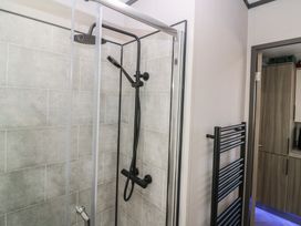 A shower with a glass enclosure and towel radiator at Plot 243 - Coldingham Bay Leisure Park Eyemouth