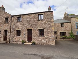 A stone house with windows and a front door at 4 Mellbecks Mews Kirkby Stephen