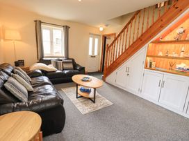A living room with sofa and coffee table at 4 Mellbecks Mews Kirkby Stephen