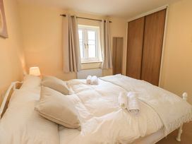 A bedroom with a bed and towels at 4 Mellbecks Mews Kirkby Stephen