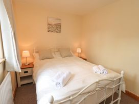 A bedroom with a double bed and nightstand at 4 Mellbecks Mews Kirkby Stephen