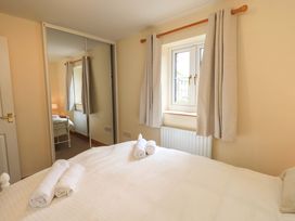A bedroom with a bed and towels on top at 4 Mellbecks Mews in Kirkby Stephen