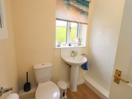 A bathroom with a toilet and sink at 4 Mellbecks Mews in Kirkby Stephen