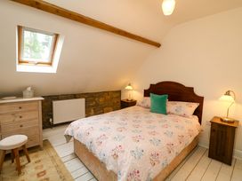 A bedroom with a bed and dresser at Childwall Cottage TULLOGHER
