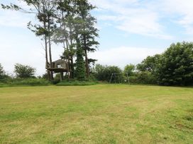 An outdoor area with a tree house and swing at Childwall Cottage, TULLOGHER