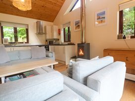 A living room with a wood stove and sofa at The Lodge at Lamburn