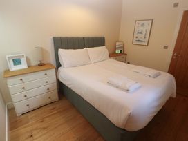 A bedroom with a bed and dresser at The Lodge at Lamburn