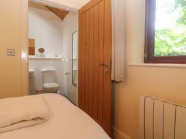 A bedroom with a towel on the bed and a bathroom visible in the background at The Lodge at Lamburn