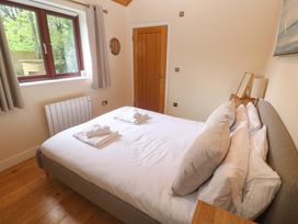 A bedroom with a bed and window at The Lodge at Lamburn
