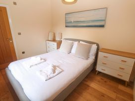 A bedroom with a bed and bedside tables at The Lodge at Lamburn