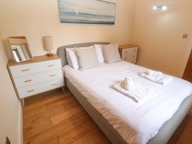 A bedroom with a bed and dresser at The Lodge at Lamburn